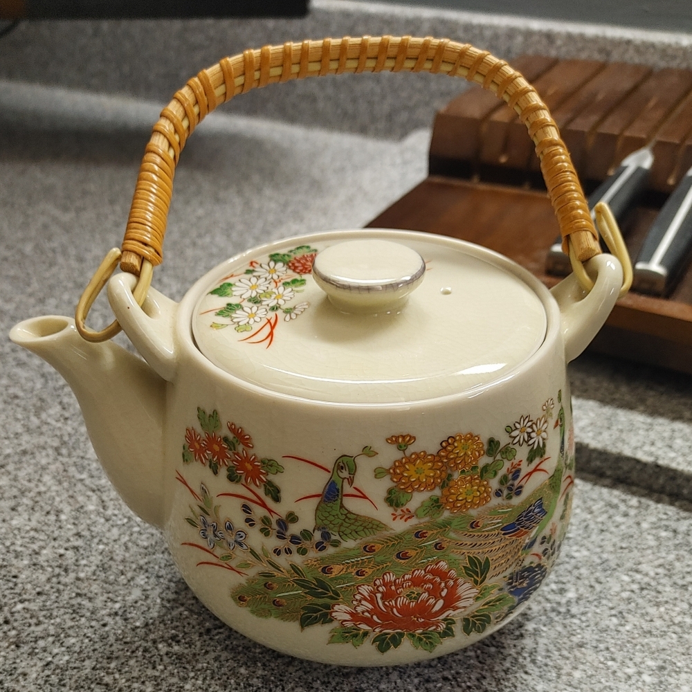 Japanese porcelain teapot with a peacock design and a bamboo handle 4"